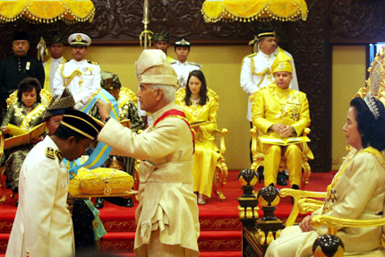 Datuk Dr. Zambry receiving a Datukship from HRH, the Sultan of Perak